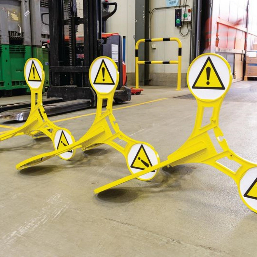 Yellow industrial safety signage by Seton shown in a warehouse factory