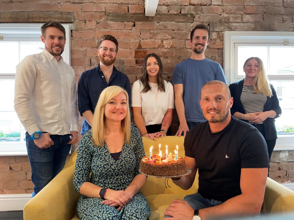 Some of the Simple Design Works team in Hereford celebrate the company's birthday in the meeting room