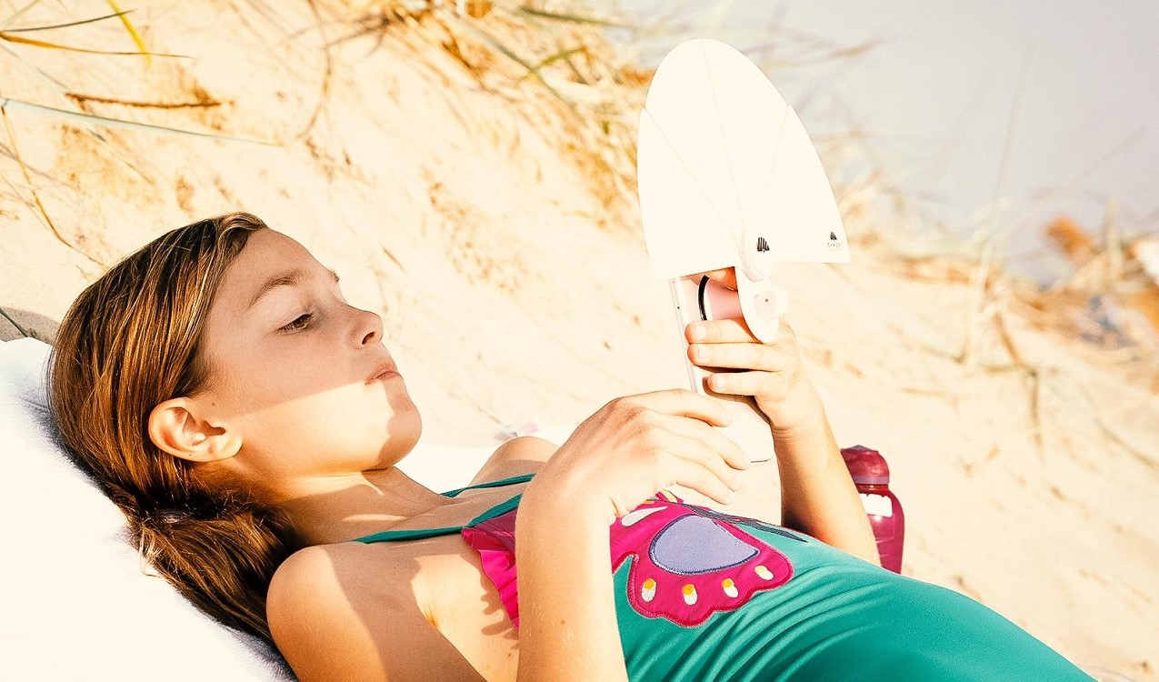 The Shadey phone product designed by Simple Design Works and being used by consumer on beach