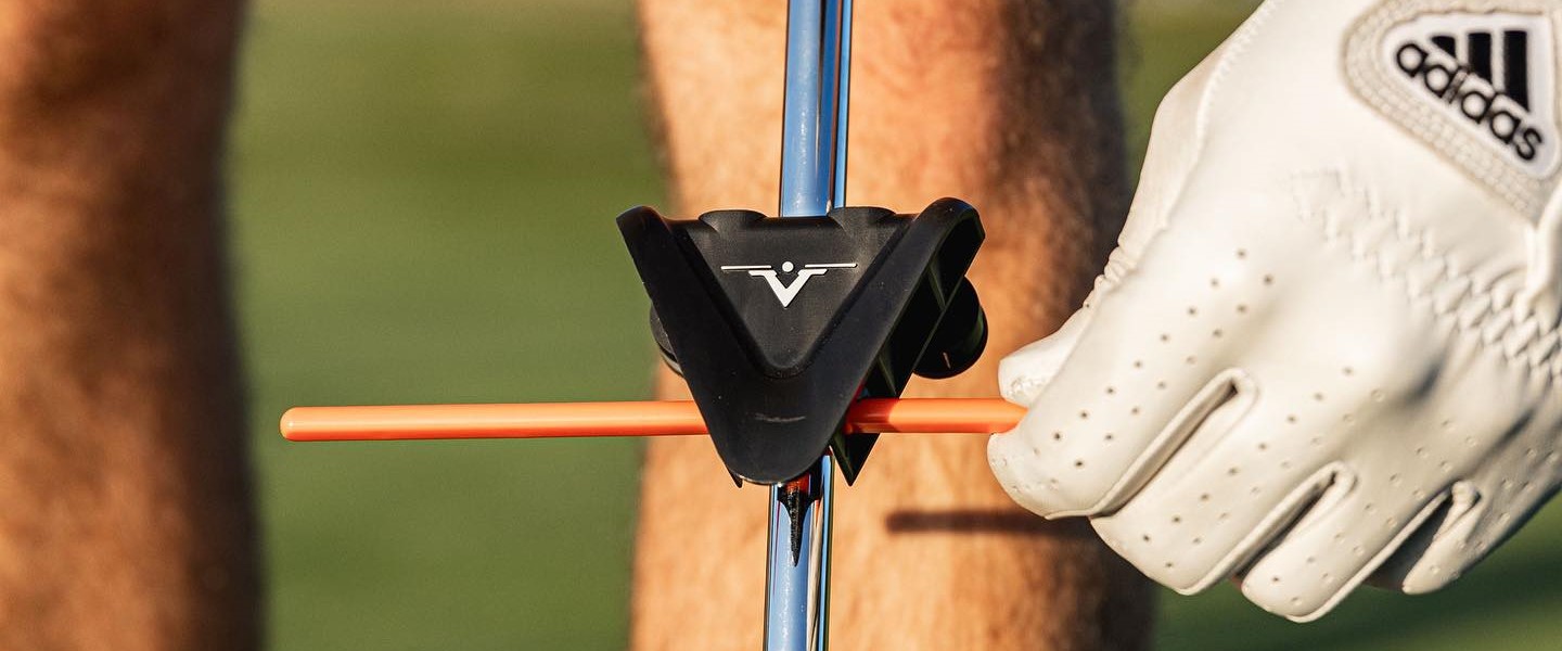 Close up of V Plane training product for golfers shown with training stick